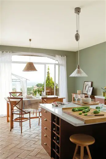 Renovation of a kitchen with green walls and a wooden floor.