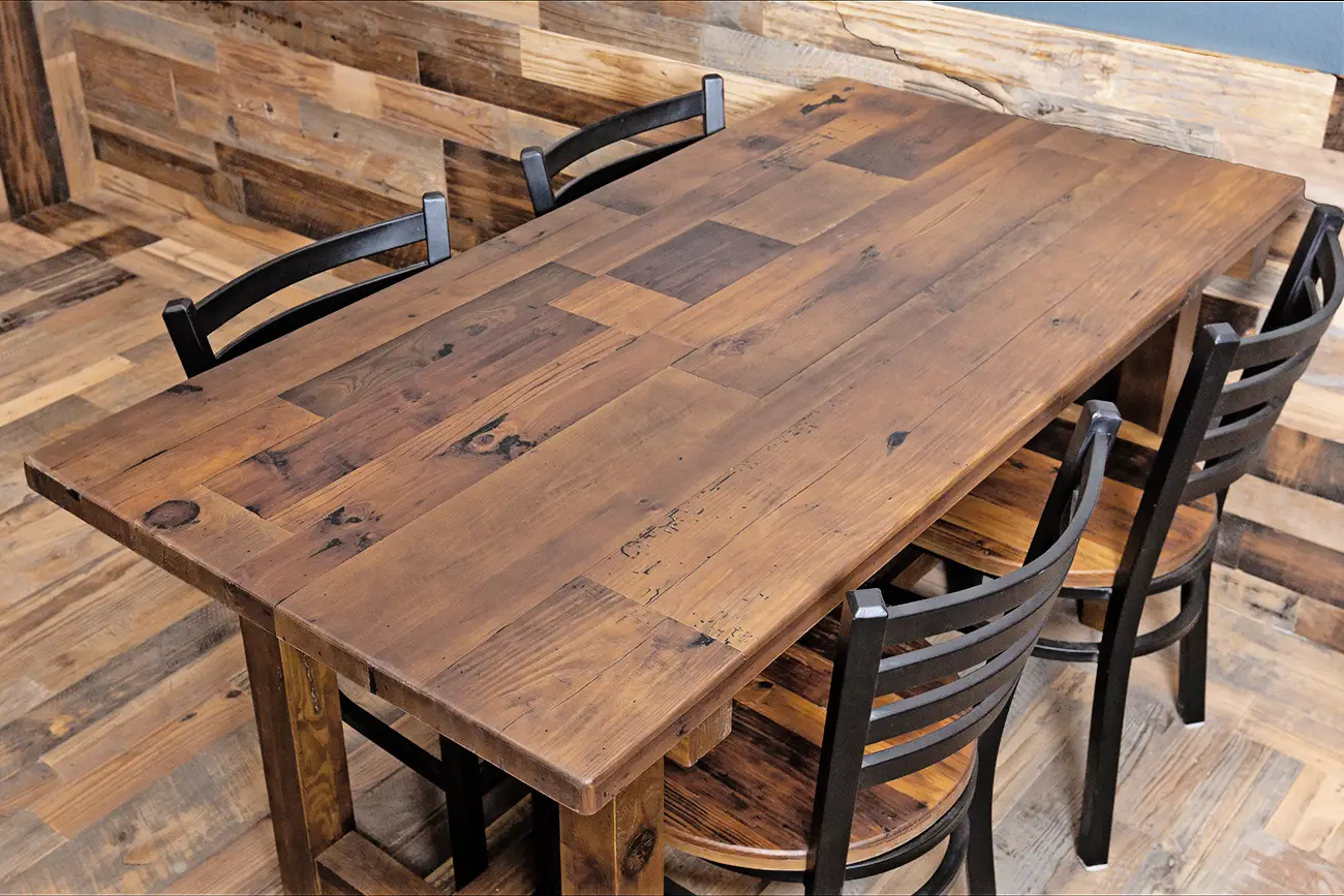 A sustainable wooden table with four chairs in a restaurant.