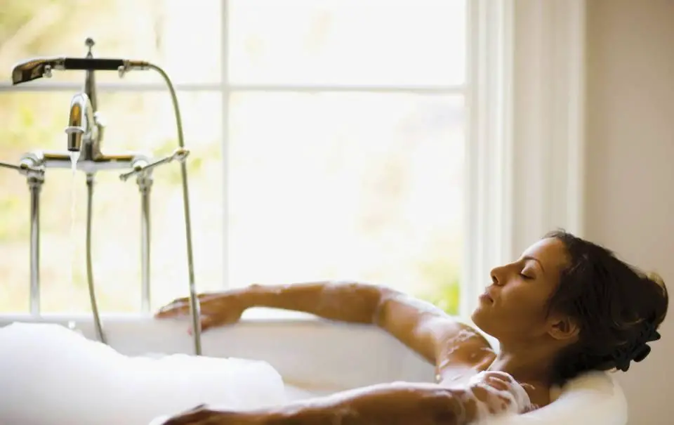 A woman enjoying a spa bath with bubbles.