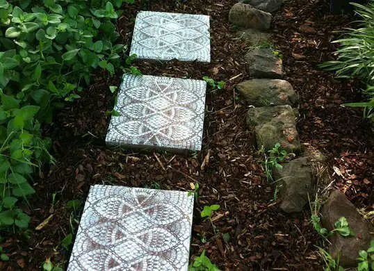 A DIY garden with stepping stones in the middle.