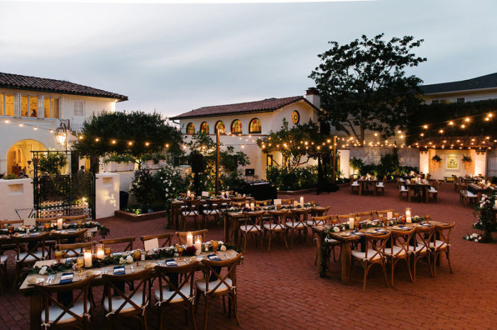 San Diego wedding reception set up in a courtyard at dusk.