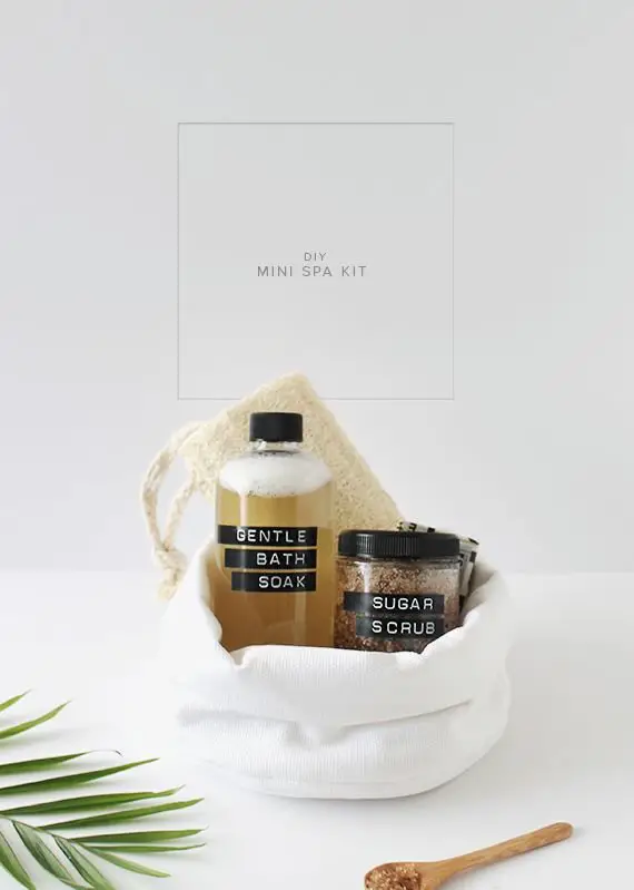 A spa-inspired bag with a bottle of soap and a wooden spoon next to it.