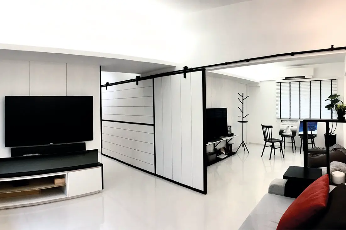A black and white living room with a TV.