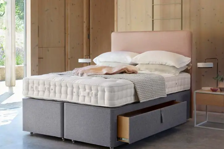 A bed with built-in drawers.