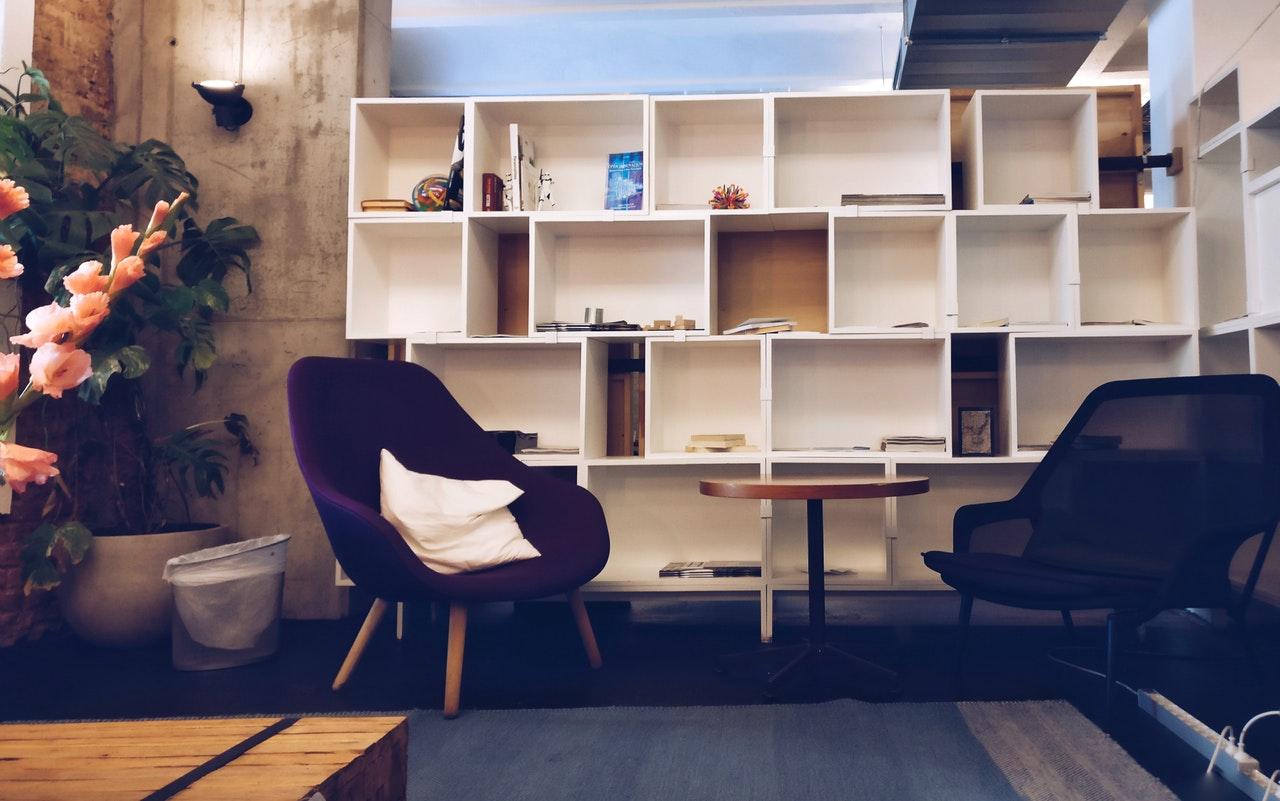 A room with furniture and bookshelves that provides tips on furniture delivery.