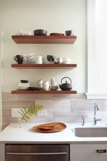 A bathroom with wooden shelves.