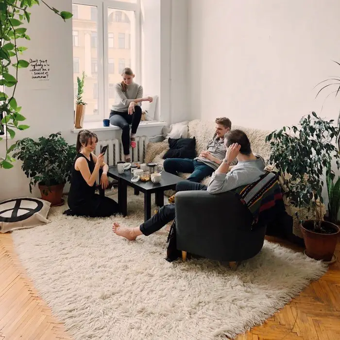People sitting on a couch in a living room, creating an inviting and cozy space.