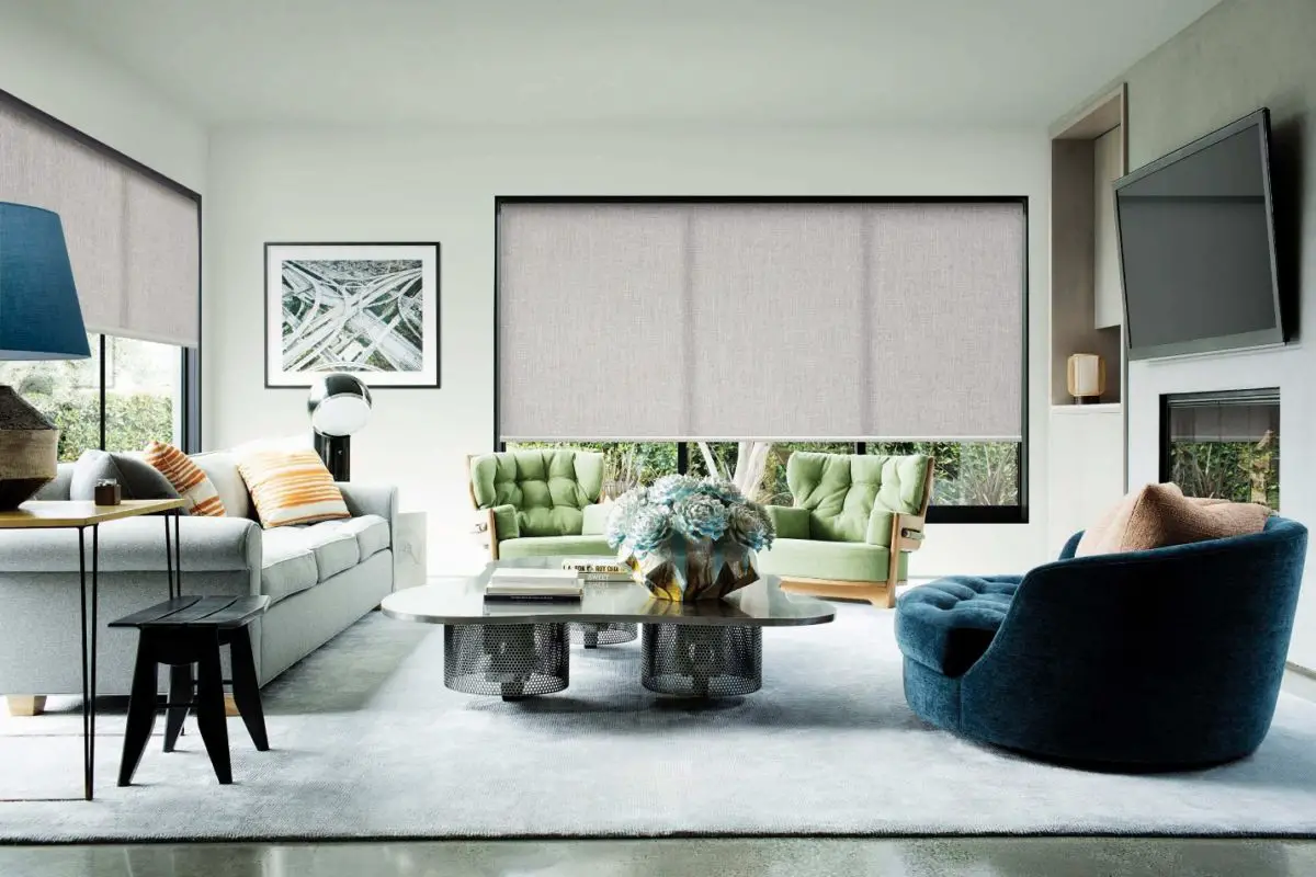 A spacious modern living room with roller shades.