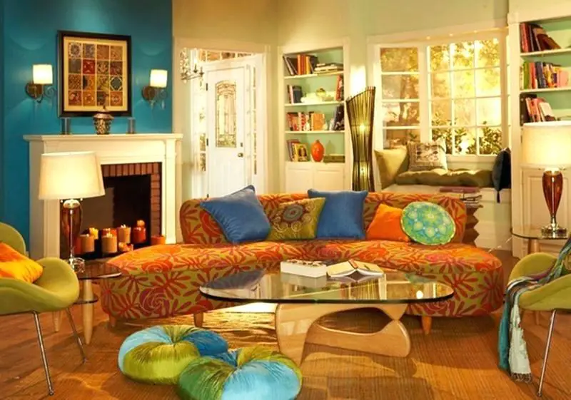 A boho chic living room with colorful furniture and a fireplace.