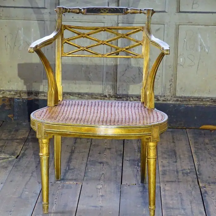 A wicker chair on a wooden floor.