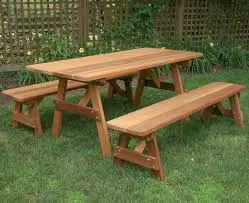 A picnic table made of wood in the yard.