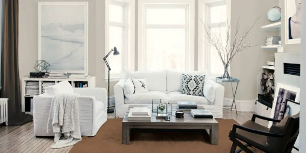 A house with white furniture and a white rug.