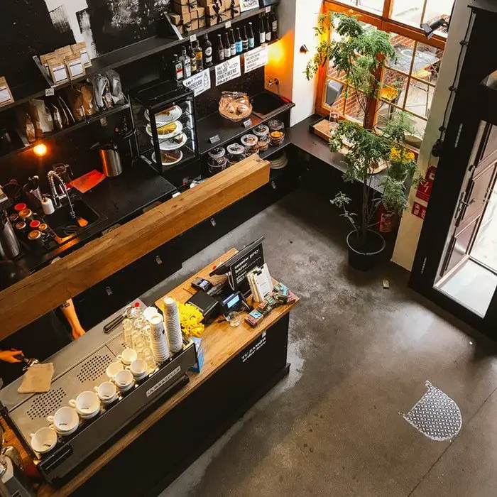 An aerial view of a coffee shop with furniture.