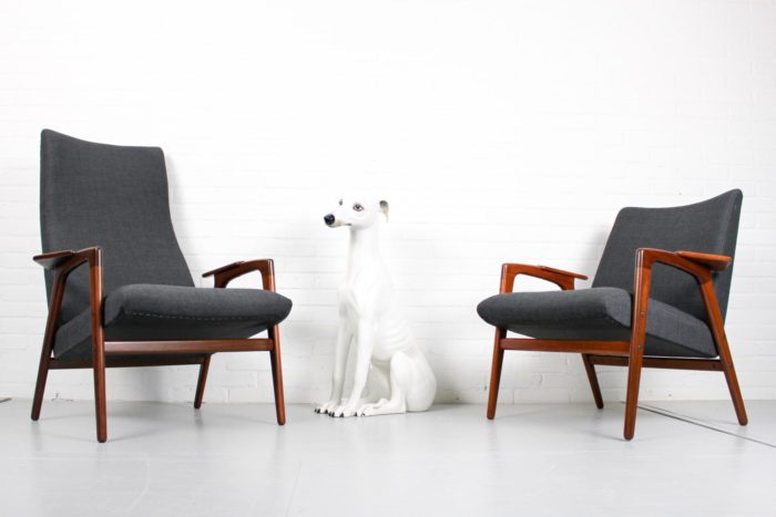 Two Mid-Century Lounge Chairs with a dog standing next to them.