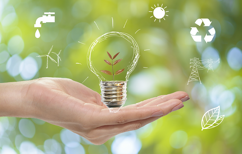 A hand holding a light bulb with eco-friendly icons promoting awareness on energy usage domestically.
