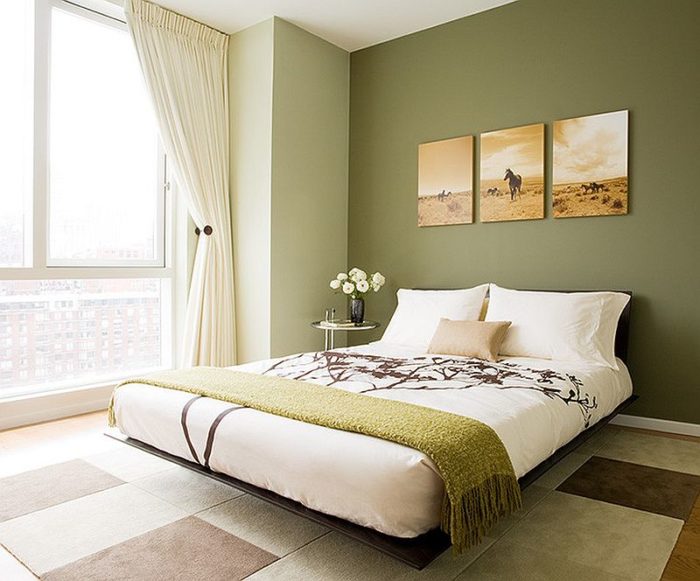 A green-walled bedroom design featuring a bed.