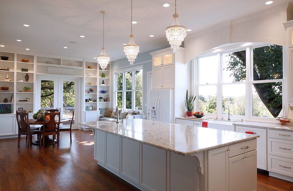 A large kitchen with white cabinets and a large island for the growing family.