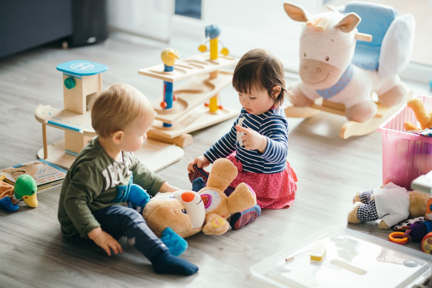 Two children enjoying toys in a cozy living room.