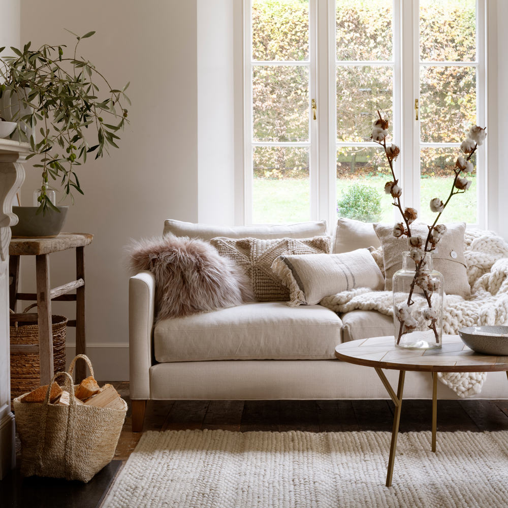A trendy living room decor featuring a white couch.