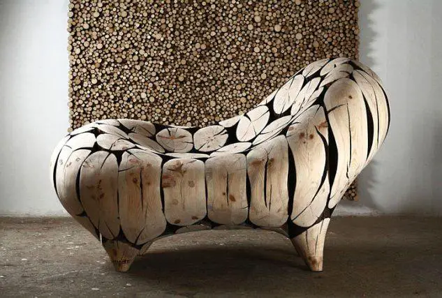 A log chair showcasing woodworking craftsmanship against a wall.