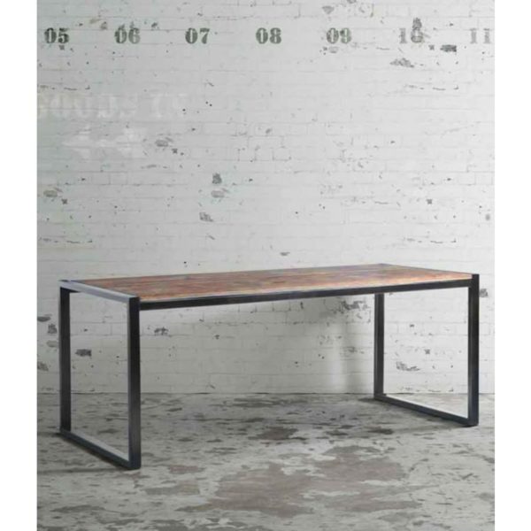 An industrial dining table with a metal frame and wood top, perfect to transform your dining garden space.