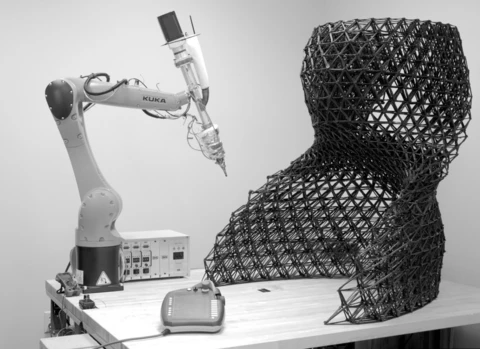 A black and white photo of a robotic chair.