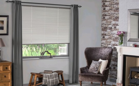 A living room with grey blinds.