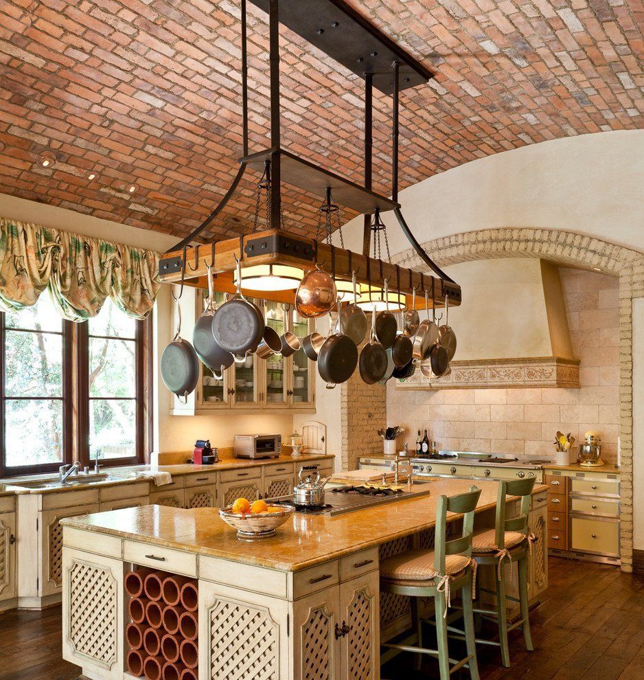 A kitchen design featuring a large island and a unique brick ceiling.