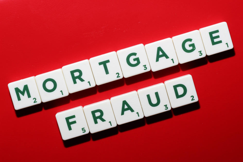 An image of "mortgage fraud" on a red background.