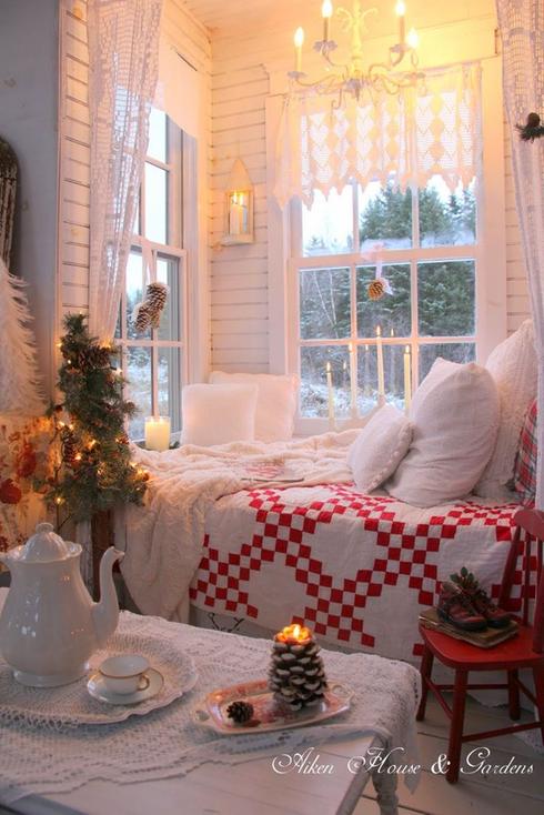 A room decorated for Christmas with a cozy bed and a festive table, perfect for nap corners.