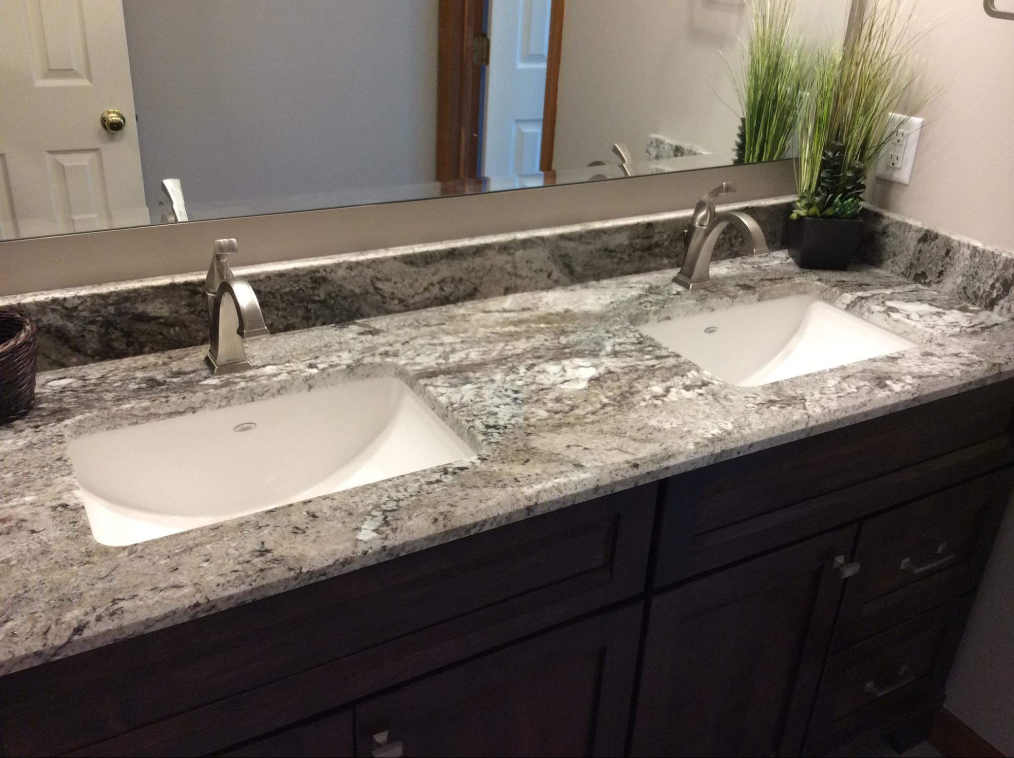 A bathroom with two sinks and bathroom countertops.