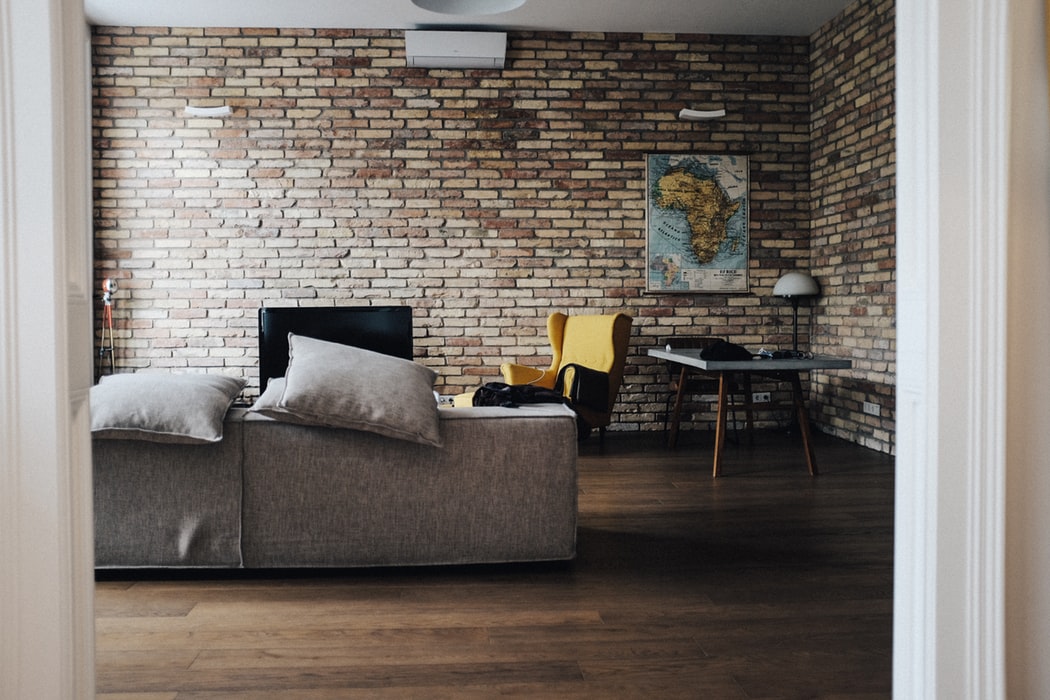 A fashionable living room with a brick wall.