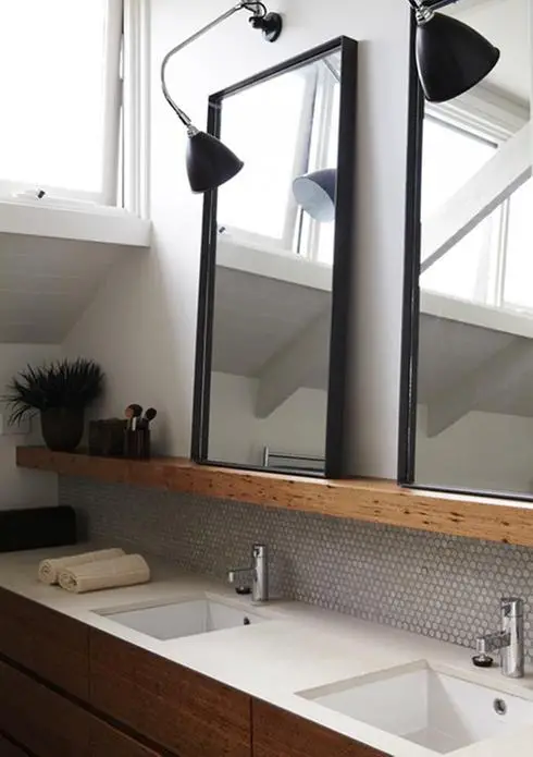 A bathroom with two sinks and two mirrors to illuminate your rooms.