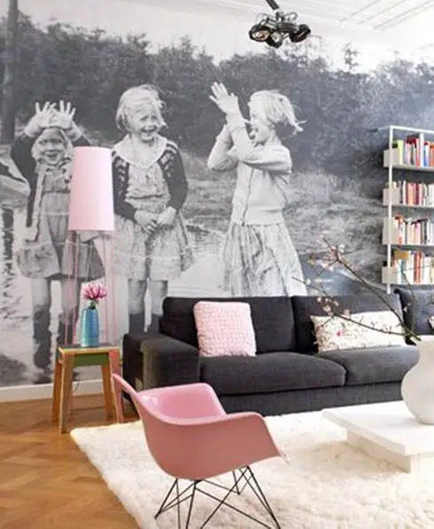 A living room with vintage decor and a black and white photo on the wall.