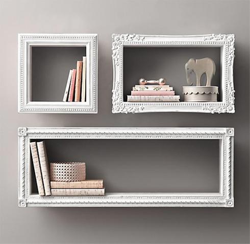 Three framed shelves with books on them, decorated with photo frames.