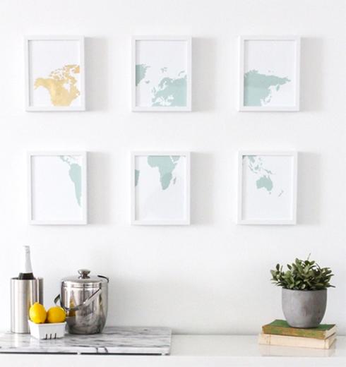 Four framed world map prints on a white wall instantaneously enhance your bedroom.