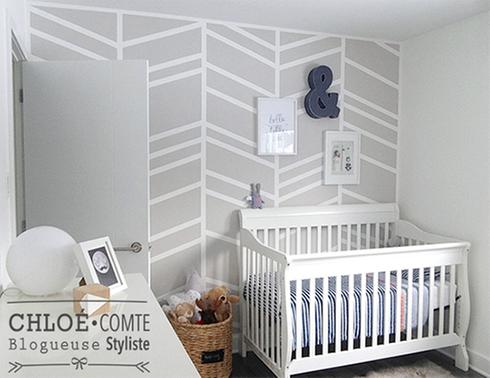A chevron-themed baby's room with a crib.
