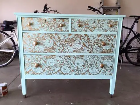 A transformable dresser with a gold and blue pattern on it.