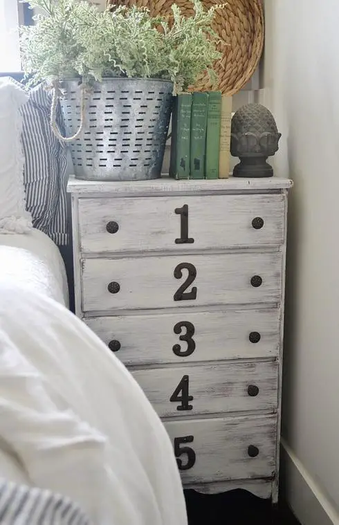 A white dresser transformed with numbers painted on it.