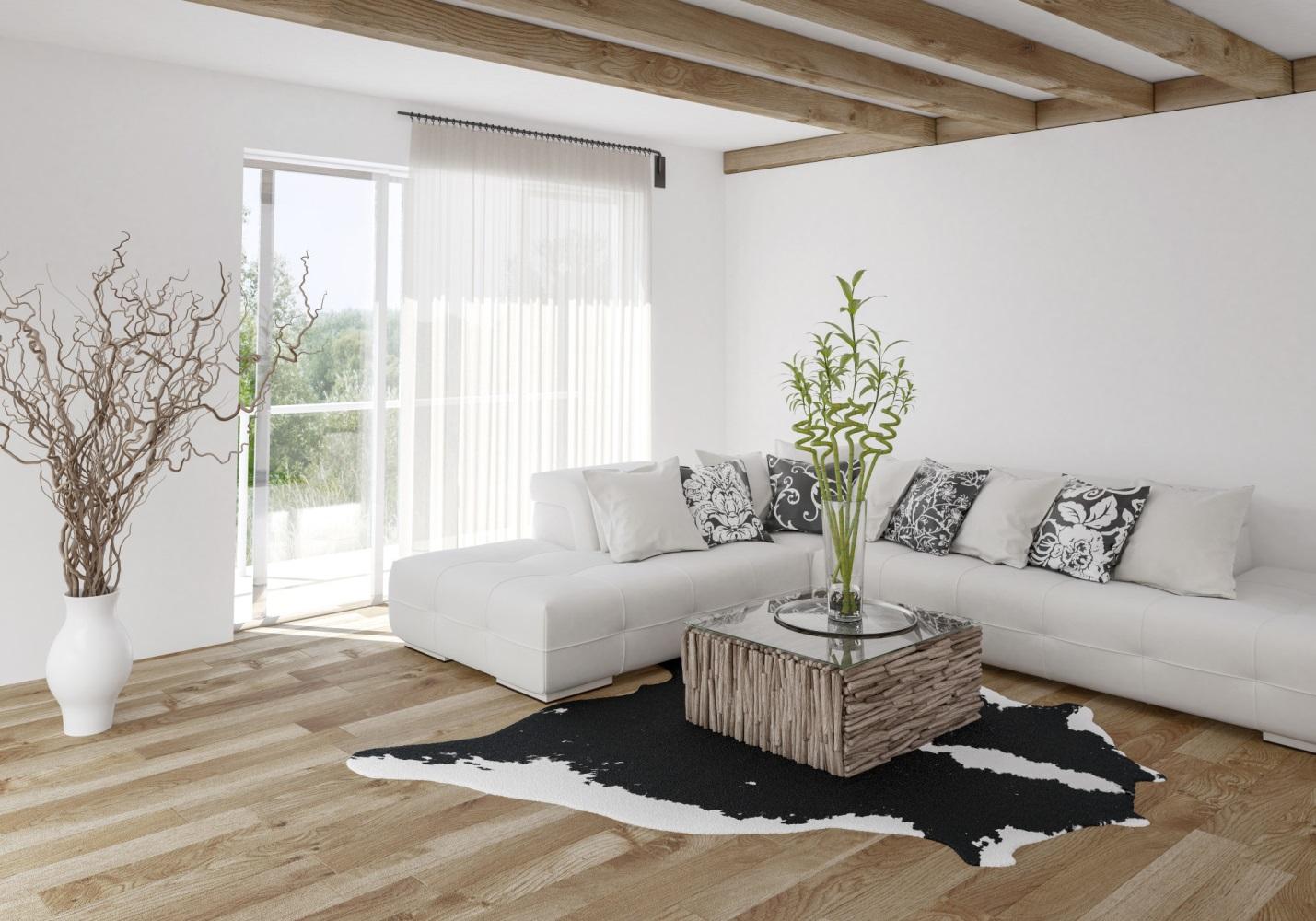 Home decor: A white living room with wooden beams and a black cowhide rug.