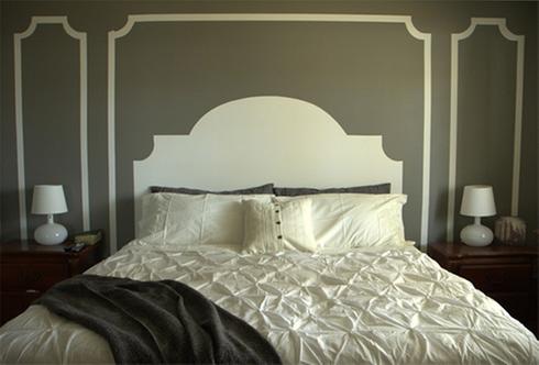 A white bed in a gray-walled bedroom.