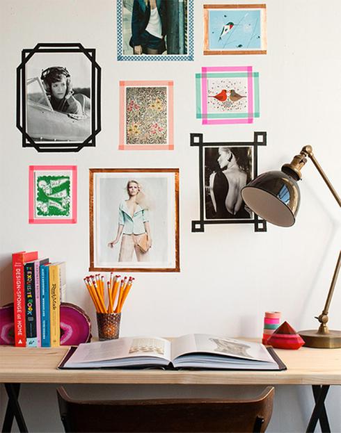Keywords: room, desk, wall. 

Modified Description: A room featuring a desk and pictures on the wall.