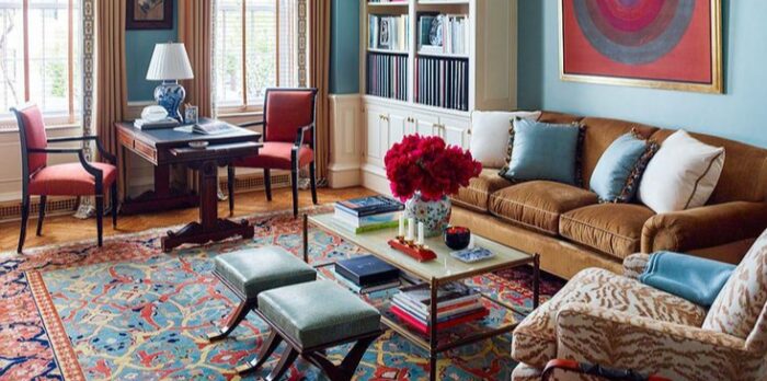 A living room with a Persian rug and blue walls.