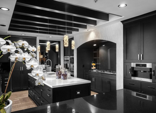 A monochrome kitchen with marble counter tops.