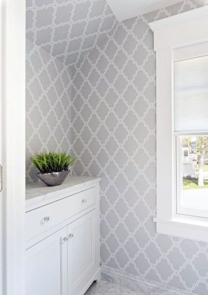 A white and gray bathroom with a trellis pattern on the wall, enhanced by bathroom wallpaper.
