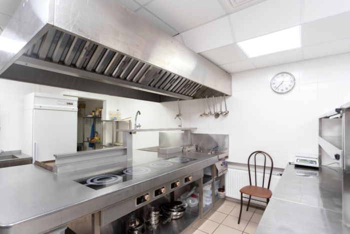 A stainless steel hood in an industrial kitchen design.