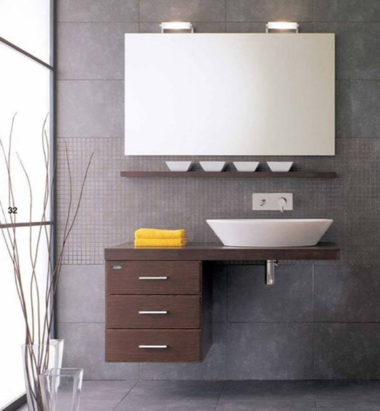 A modern bathroom with a floating vanity, sink, and mirror.