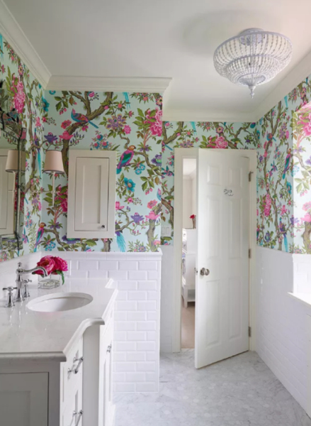 A bathroom with floral wallpaper.