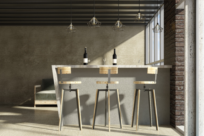 A small breakfast bar with two stools and a bottle of wine.