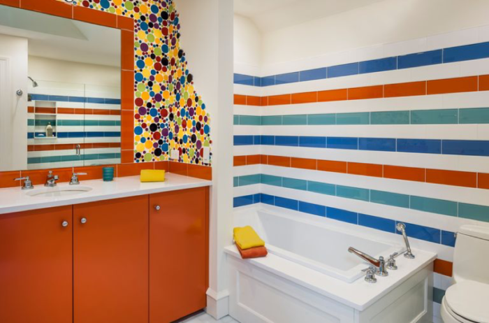 A bathroom with colorful striped wall tiles.